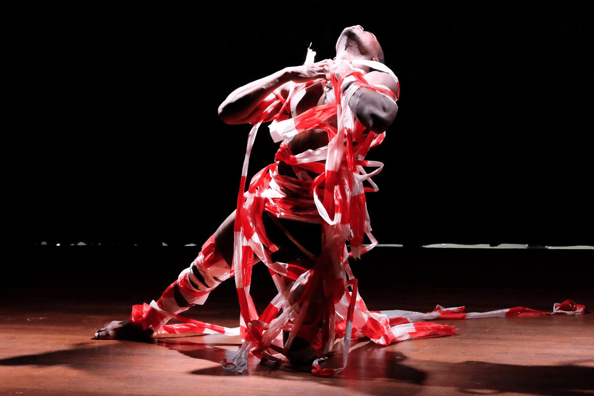 an image of an african man dressed in red an performing a spiritual dance